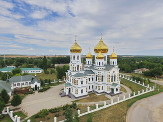Fototapeta na wymiar Church of the Holy Trinity in the village of Novodonetskaya with clouds, Krasnodar region, Russia