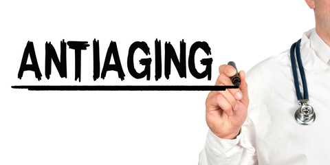 Doctor writes the word - ANTIAGING. Image of a hand holding a marker isolated on a white background.