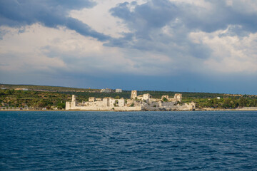 Panoramic view onto medieval castle Korykos, walls & towers. Object is in tentative UNESCO List. Resort city Kizkalesi on background. Located in Southern Turkey on Mediterranean sea shoreline