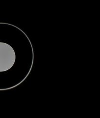 Fototapeta premium White glowing circles on a black background.