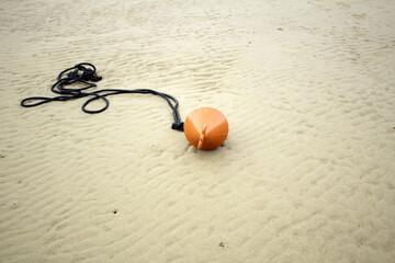 Buoy on beach sand