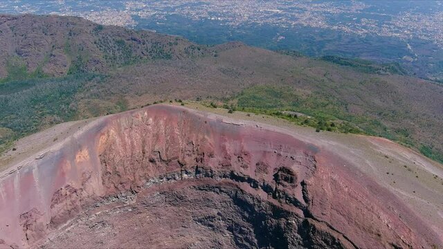 Aerial view of volcano Mount Vesuvius, rough volcanic terrain inside crater on top of mountain - landscape panorama of Naples from above, Italy, Europe