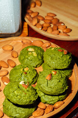 White chocolate matcha  brownie cookies , Almonds and iced milk  in wooden tray  on table, Delicious homemade
