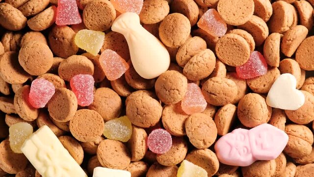 Rotation of kruidnoten, traditional sweets, strooigoed. Background for Dutch holiday Sinterklaas. St. Nicolas day concept. 4K video, 50 fps, top view