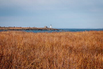 A distant lighthouse above an amber field. - 376940015