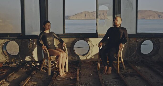 Psychodellic frame, weird couple sitting in broken home. Romantic concept, Filmed on cinema camera, 12 bit coolor