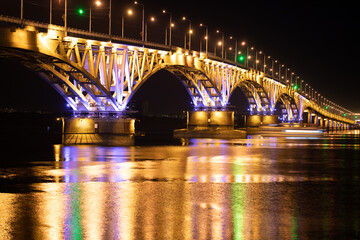 The bridge across the river glows at night