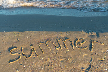 word beach written on the sand, inscription on the beach