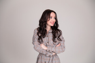 Beautiful girl student, business woman smiles on white, grey background