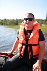 Man in life jacket on boat