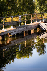 Fototapeta na wymiar mooring dock on the side of a canal, calm reflective water and sunshine