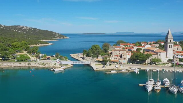 Beautiful old historic town of Osor, marina and bridge connecting islands Cres and Losinj, Croatia, aerial view from drone
