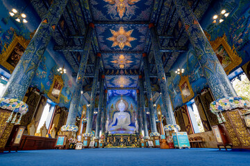 Chiangrai, Thailand - September 02, 2020: Big White Buddha Image located in Main Blue Chapel of Wat Rong Suea Ten Temple, The Blue Temple, landmark of Chiangrai Province