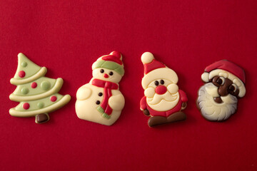 Assortment of Christmas chocolate bonbons on red background