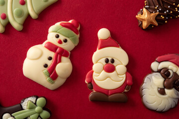 Assortment of Christmas chocolate bonbons on red background