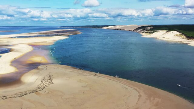 Banc d'Arguin at Arcachon Bay France with boats anchored along the coast, Aerial dolly left view