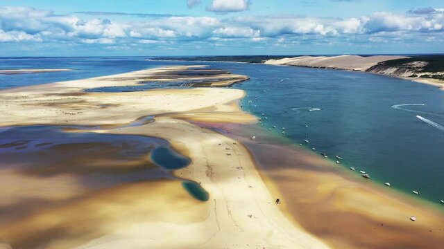 Arcachon Bassin France over Banc d'Arguin with boats anchored on the south passage, Aerial dolly out reveal shot