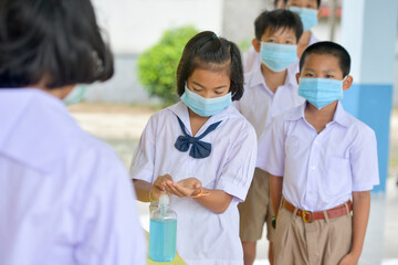 Washing Hand By Sanitizer Gel For Prevention Coronavirus Disease (Covid-19) in classroom.Washing hands by alcohol sanitizers or alcohol gel from pump bottle in public area.