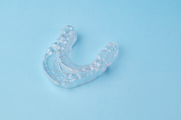 Two removable braces on the blue background. Invisible aligners for whitening teeth at home by yourself.