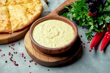 Georgian dish shusha - mashed potatoes with milk and melted cheese in a composition with khachapuri on a gray background