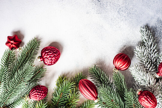 Christmas ornaments next to fir branches