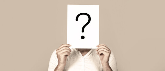 Man a question. Doubtful man holding Question Mark. Question mark, symbol. Pensive male. Getting...