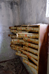 An old broken mailbox in an apartment building.