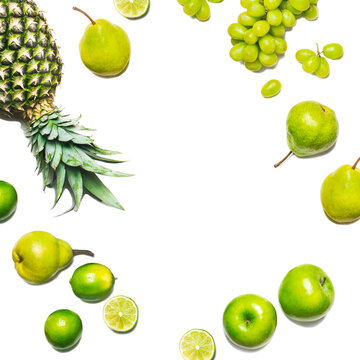 Apples, pears, grapes, lime and a pineapple on a white background