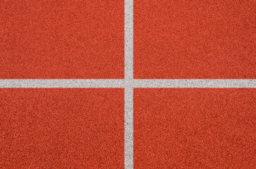 Top view of the running track rubber lanes cover texture with white line marking for background.