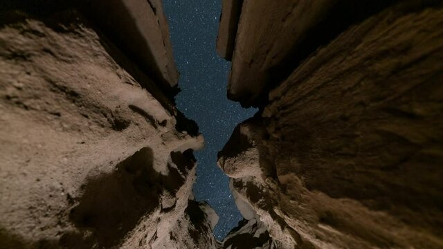  Astro timelapse low angle tracking shot of stars thru sandstone cave in Mojave Desert, California