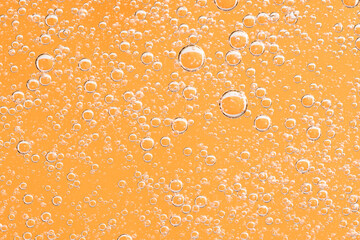 Yellow and orange bubbles, drops of oil in water, olive oil for cooking background.