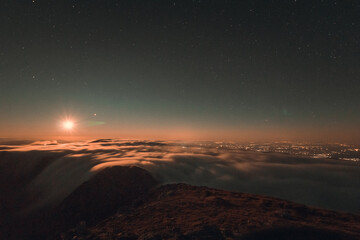 Moonrise, comet and stars landscape above the mountain in autumn season