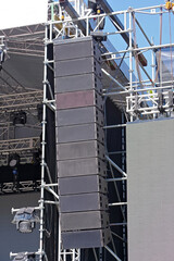 speakers hanging for an outdoor concert