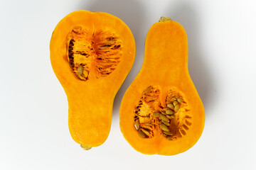 Sliced pumpkin with seeds and pulp on a white background. Copy space. Horizontal orientation. Minimalism.