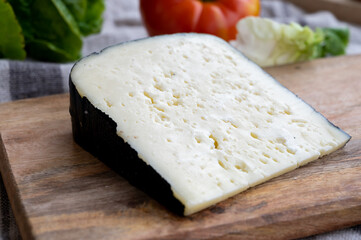 Cheese collection, French fol epi  cheese with many little holes, etorki, tomme noire des pyrenees and ossau iraty cheese