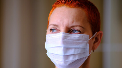 Medical mask on the girl's face. Personal protective equipment. The concept of preventing the spread of the virus during an epidemic.