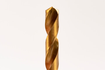 Macro abstract of titanium drill bits on workbench.