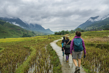 Tourist guided by two local women in the sapa valley of vietnam
