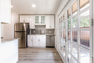 New modern kitchen in an apartment with stainless steel appliances. Real photo