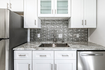 New modern kitchen in an apartment with stainless steel appliances. Real photo