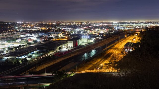  Timelapse of highway traffic over railroad tracks in Los Angeles, California