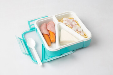 Opened tiffin box carrier with food isolated on white