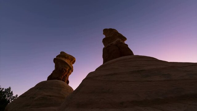  Time lapse tracking shot of sunrise illuminating hoodoos at Devils Garden in Grand Staircase Escalante National Monument in Utah