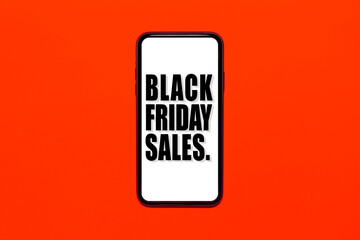 Text of black friday sales on smartphone screen. Background of red or lush lava color.