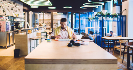 Businessman working with documents in cafe