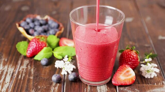 berry fruit smoothie pouring- healthy lifestyle