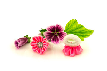Fototapeta na wymiar Barrette with pink ribbon and elastic, flowers and green leaf isolated on white background.