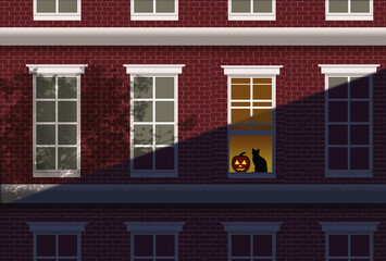 Naklejka premium A jack-o-lantern and a black cat are seen in the window of an urban apartment building.