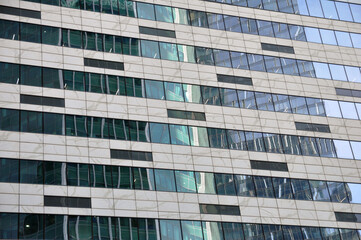 Abstract modern building background for design. Glass architecture of a modern building. The texture of the windows of the building.