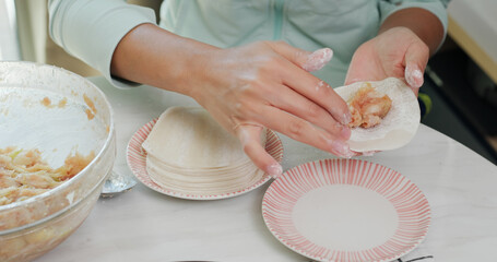Woman making meat dumpling at home